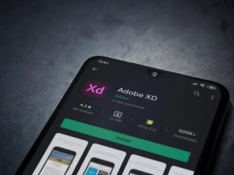 Adobe XD app play store page on the display of a black mobile smartphone on a Foto stock