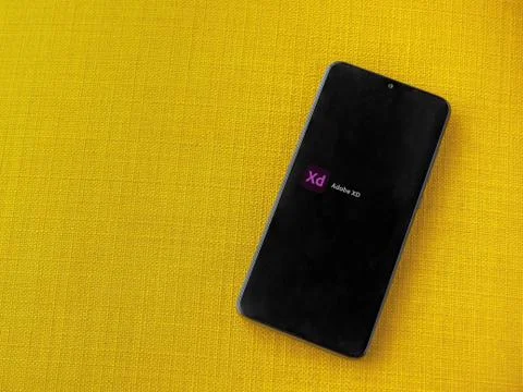 Adobe XD app play store page on the display of a black mobile smartphone on a Stock Photos