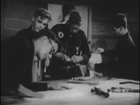 An adolescent boy works in a workshop with boy scouts and builds sets, Stock Footage 74935175