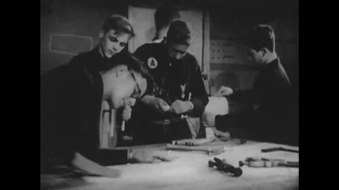 An adolescent boy works in a workshop with boy scouts and builds sets, outdoors, Stock Footage 137250485