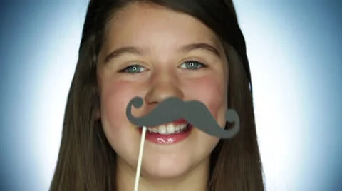 An adolescent smile and keeps puppet mustache in his lips Stock Footage 22931338