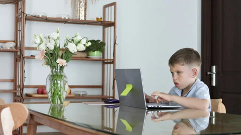 Adolescent student focused on completing online schoolwork in home environment. Stock Footage 310933163