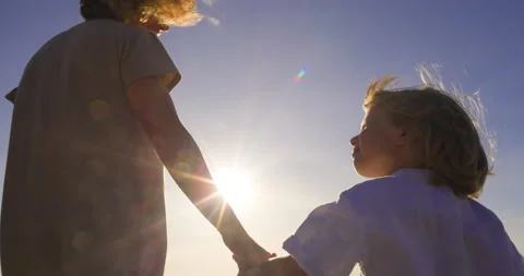The adoptive mother extends her hand to her adopted child while they walk and Stock Footage 233718731
