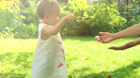 Adorable baby girl making her first steps Stock Footage