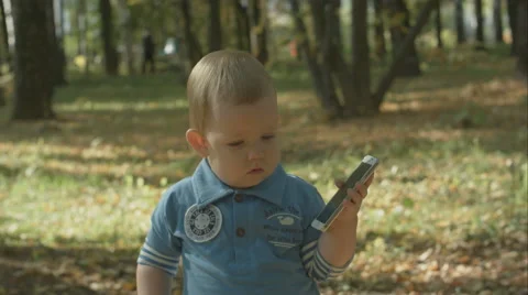 Adorable baby stops calling with cell phone 스톡 동영상 56203499