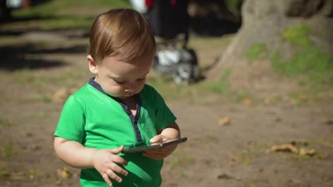 Adorable baby stops calling with cell phone Stock Footage 304366284