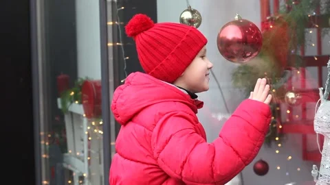 Adorable boy kid looking through the display window at Christmas decoration in Stock Footage 166795729