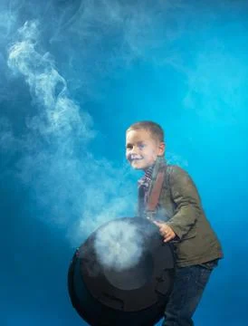 Adorable boy posing in cloud of steam, close-up Stock Photos