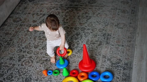 Adorable Caucasian boy assembling toy pyramids. Stock Footage 237729082
