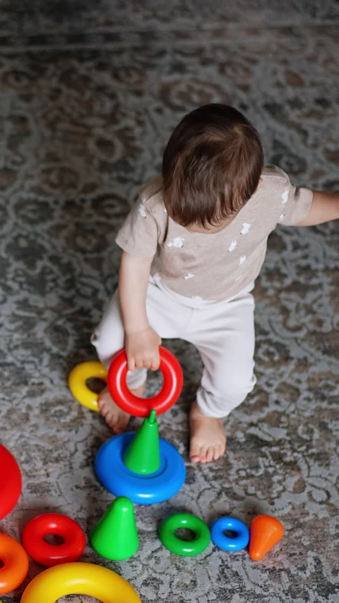 Adorable Caucasian boy assembling toy pyramids.  Stock Footage 313109764