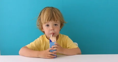 Adorable child drinking from box through straw Stock Footage 111757897