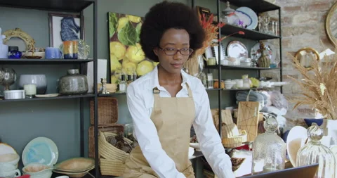 Adorable contented smiling young black-skinned woman with african hairstyle in Stock Footage 143929357