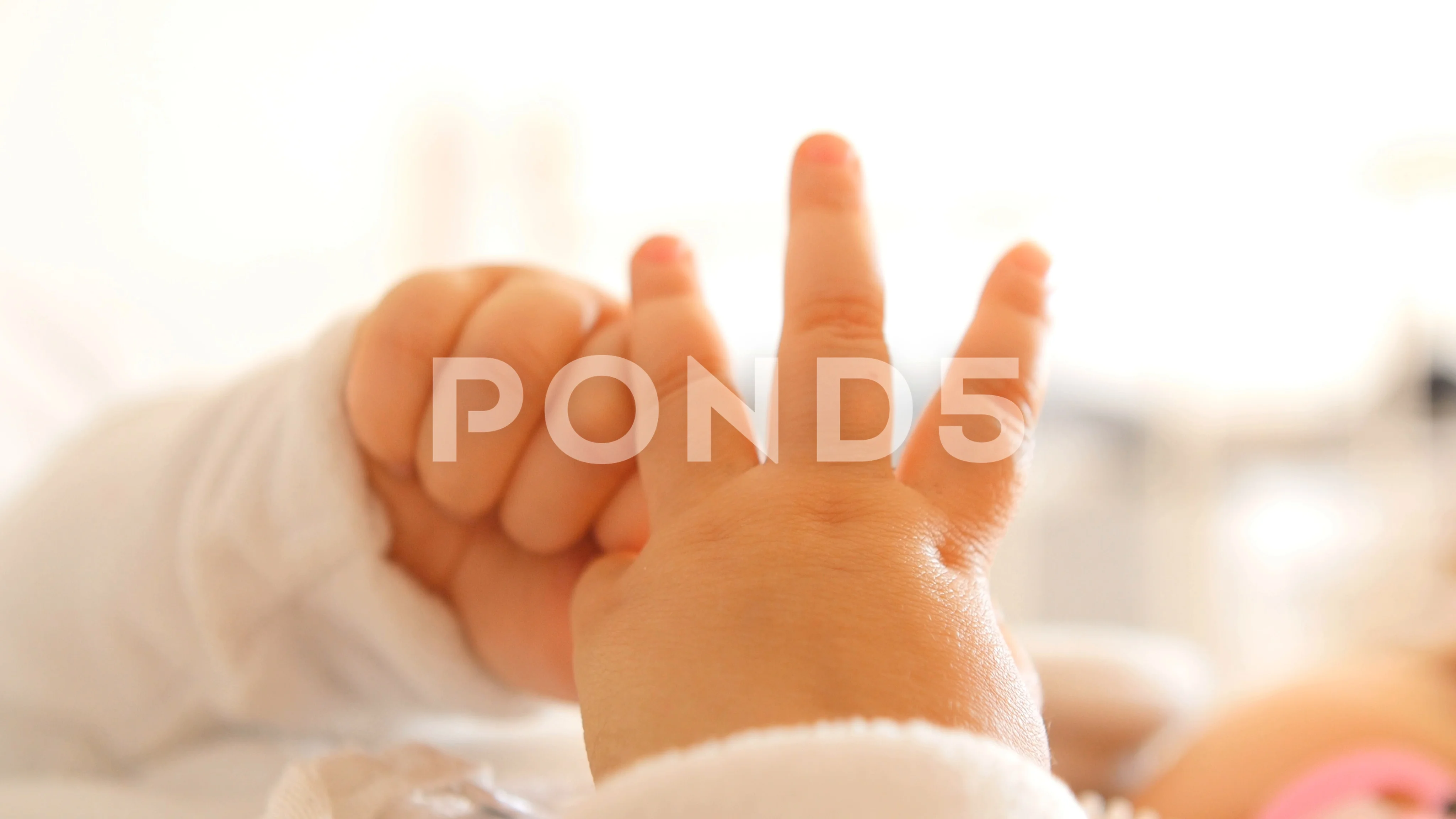 Baby playing with store hands