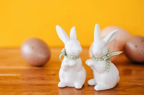 Adorable Easter bunny standing in front of a traditional Easter cake Stock Photos