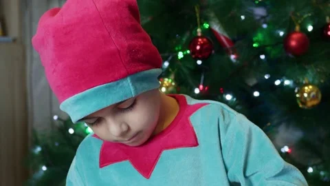 Adorable elf boy fixing toys for kids. Revealing tilting down shot Stock Footage 259386366
