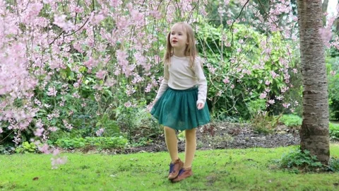 Adorable girl enjoying nice spring day in park Stock Footage 316893473
