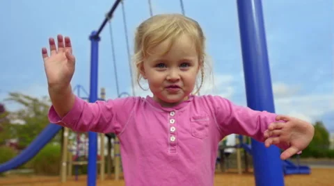 Adorable girl waves at the camera Stock Footage 56692834