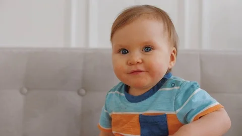 Adorable happy little boy with blue eyes smiles and rejoices at home, close up Stock-Footage 124751653