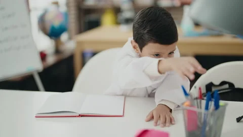 Adorable hispanic boy student drawing on... | Stock Video | Pond5