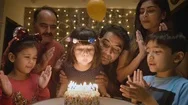 An Adorable Indian Girl Child Blowing Candles On A Cake With Family And Friends Stock Footage