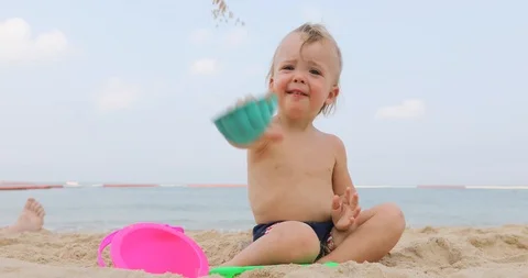 Adorable infant on sandy beach Stock Footage 88435036