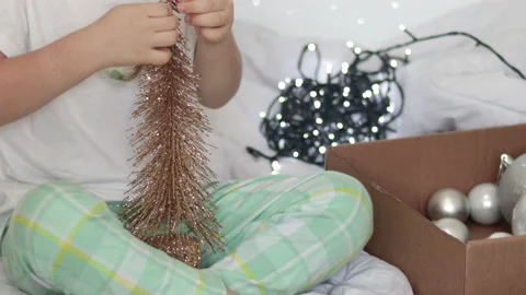 Adorable kid boy in pajama playing with christmas decorations lights Vidéo 221252020