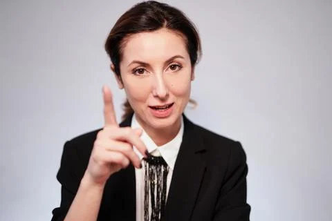 Adorable lady in black jacket posing on isolated background looking at camera Stock-Fotos