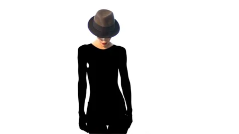 Adorable lady in hat with deep black shadow on her body Stock Footage