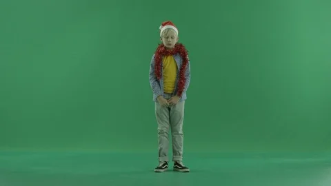 Adorable little boy clicks his fingers, green chroma key background Stock Footage 86207053