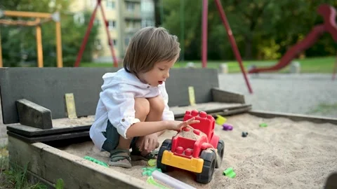 Adorable little boy having fun on a playground on bright sunny summer day. 스톡 동영상 313571268