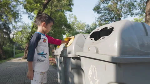 Adorable little boy keep drinking water to trash can garbage bin Video stock 286007922