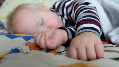 Adorable little boy sleeping in bed. A special filter that emphasizes a sleepy a Stock Footage 82278942