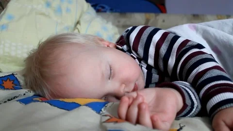 Adorable little boy sleeping in bed. A special filter that emphasizes a sleepy a Vidéo 82278943