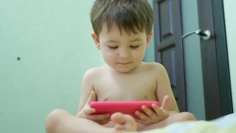 Adorable little kid son using smartphone watching funny videos Stock Footage 151074971