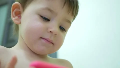 Adorable little kid son using smartphone watching funny videos Stock Footage 151075156