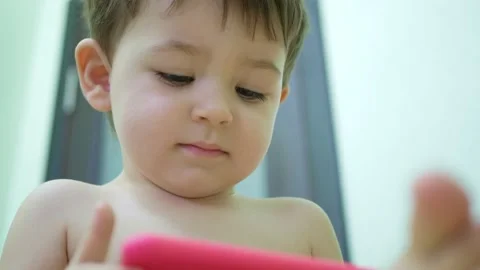 Adorable little kid son using smartphone watching funny videos Stock Footage 151078894