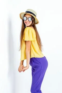 Adorable model posing in hat and casual clothes Stock Photos