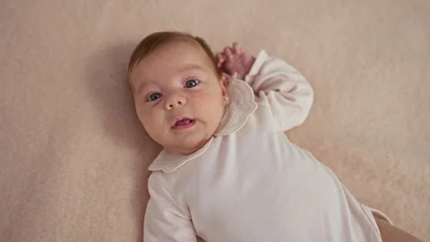 Adorable newborn boy lying on bed in bright bedroom home interior Stock Footage 293767008