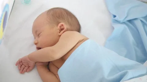 Adorable newborn kid smiling while falling asleep. Handheld shot 스톡 동영상 67173421