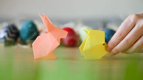 Adorable paper Easter bunny and chick meet infront of colorful Easter eggs. Stock Footage 149062477