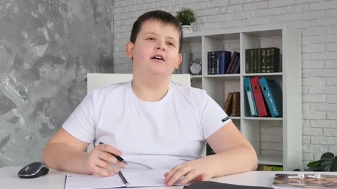 Adorable small 9s kid boy wearing wireless headphones, looking at camera Stock Footage 232892232