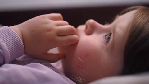 Adorable small child asleep on soft pillow sheets covered with blanket Stock Footage 243564783