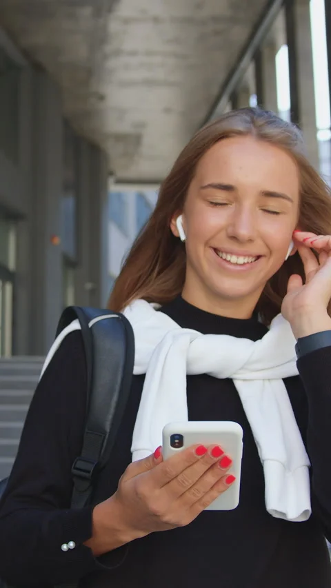 Adorable smiling relaxed 20-aged girl in casual clothes enjoying favourite songs Stock Footage 330181500