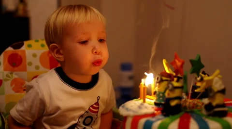 Adorable three year old boy celebrating his birthday and blowing candles Stock Footage 47806907