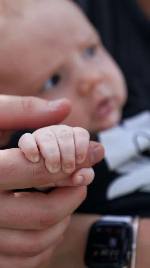 Adorable tiny baby resting in hands of his mom. Stock Footage 310390354