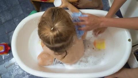 Adorable toddler boy taking a bath with mother. Stock Footage 284228087