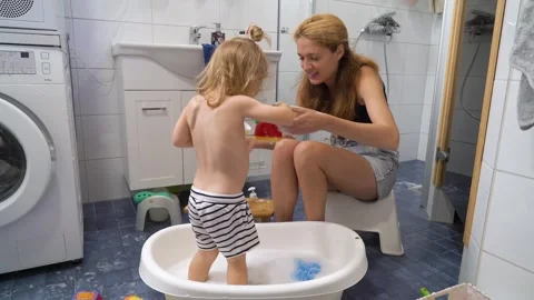 Adorable toddler boy taking a bath with mother. Stock Footage 284426645
