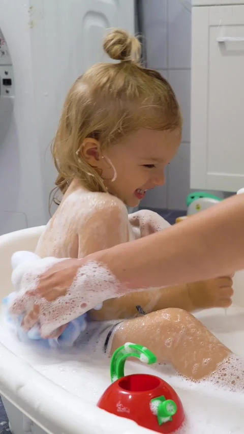 Adorable toddler boy taking a bath with mother. Stock Footage 284426828