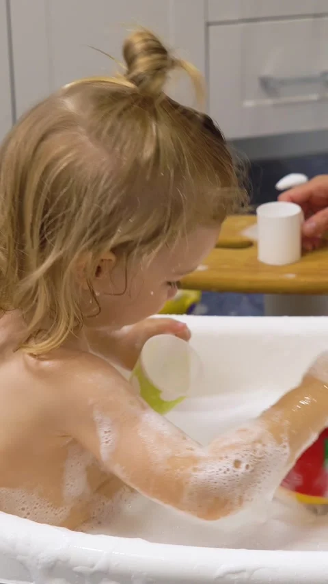Adorable toddler boy taking a bath with mother. Stock Footage 284426896