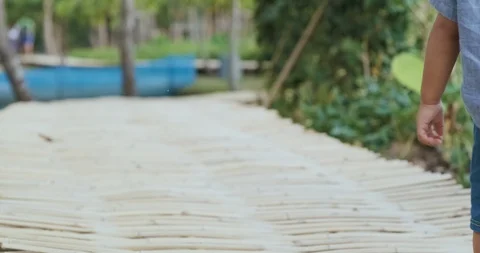 Adorable toddler boy walking practice in city park sunset light Stock Footage 129908768
